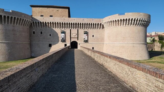 Rocca Roveresca Castle of Senigallia, Ancona and its access bridge, with full day light in summer time. Building recently cleaned in 2026. Front side view, horizontal footage panning.