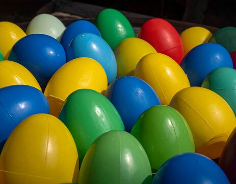 Close-up of numerous colorful plastic egg shapes, tightly arranged together