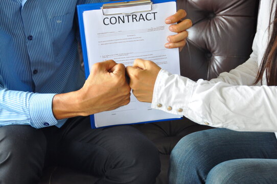 Trustworthy meeting business concept. Success collaboration partners sign contract and shake hands after success business joint venture deal. Shakehand teamwork partners at modern office handshake