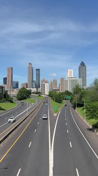 View of downtown Atlanta and the freeway from Jackson Street Bridge in Georgia on a sunny summer afternoon.