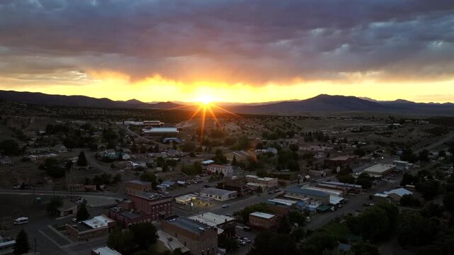 Eureka Nevada - Aerial Approach of Downtown Eureka NV Facing West at Sunset with Vibrant Sun Star