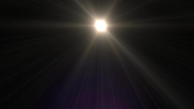 Bright light emits sharp rays against a black backdrop