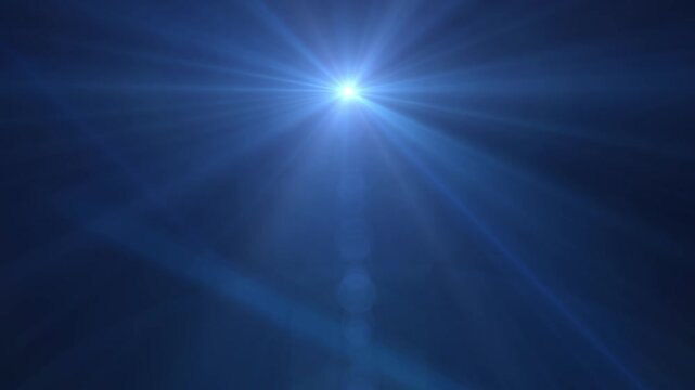 Bright blue light bursts into view with sharp rays. Deep blue background offers stark contrast