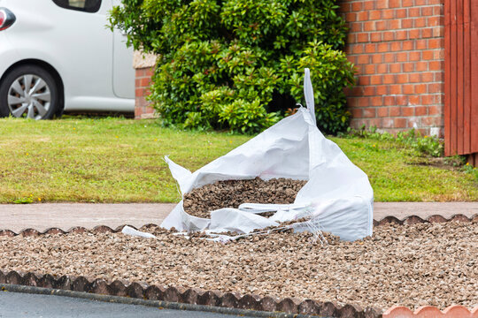Bulk bag of gravel split open during domestic landscaping project