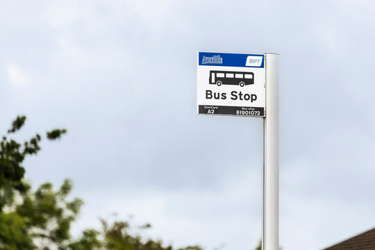 COYLTON, UK - JUNE 07, 2025: Modern Bus Stop Sign Against Cloudy Sky