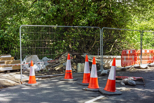 Temporary fencing and traffic cones around bridge repair worksite