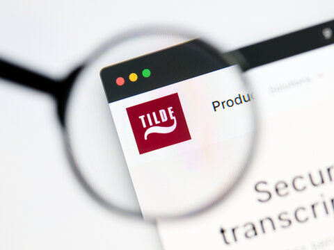 Milan, Italy 2026, 5 Jul Closeup of Tilde website page on a laptop screen. Focus on Tilde logo under a magnifying glass.