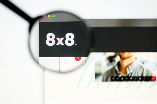 Milan, Italy 2026, 5 Jul Closeup of 8x8 website page on a laptop screen. Focus on 8x8 logo under a magnifying glass.