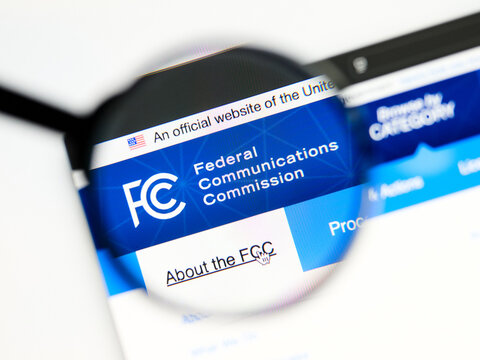 Milan, Italy 2026, 5 Jul Closeup of Federal Communications Commission website page on a laptop screen. Focus on Federal Communications Commission logo under a magnifying glass.