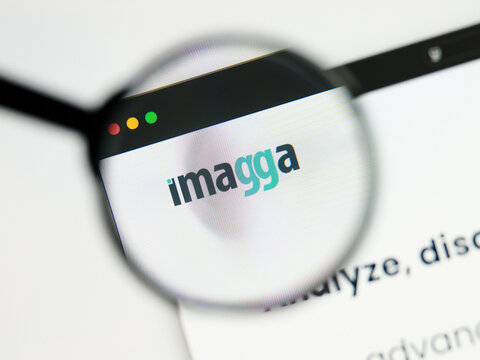 Milan, Italy 2026, 5 Jul Closeup of Imagga website page on a laptop screen. Focus on Imagga logo under a magnifying glass.