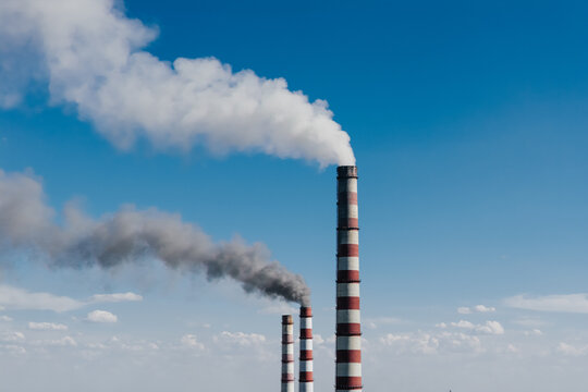 Aerial close-up of an industrial smokestack at a power plant.