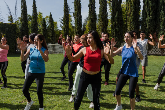 Large Group of Latin and diverse people in Zumba class outdoors in a public park in Mexico Latin America