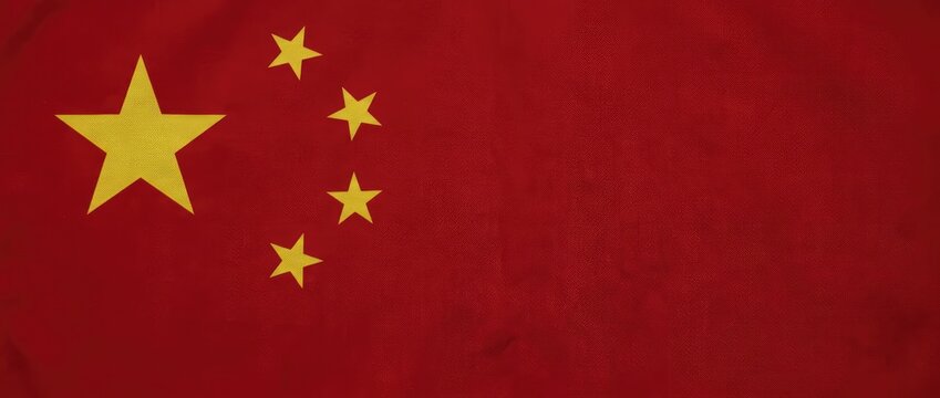 A close-up of the Chinese national flag, a vibrant red fabric adorned with five golden stars. The stars symbolize the unity of the Chinese people under the leadership of the Communist Party