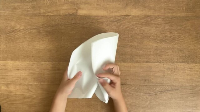 Child's Hands Crumple a White Sheet of Paper into a Ball, 4K