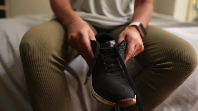Athletic woman tying shoelaces before training workout
