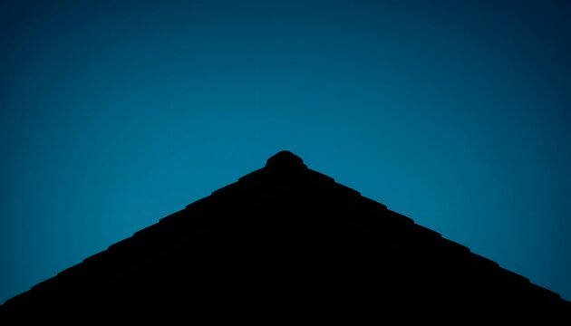 Minimalist silhouette of a residential roof peak against a deep blue evening sky creating a sharp geometric contrast in an architectural composition