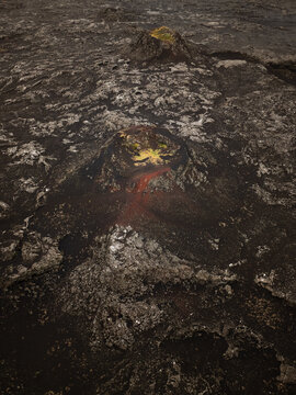 Aerial view of volcanic craters and solidified lava fields with patches of moss in Reykjanesbaer, Iceland.
