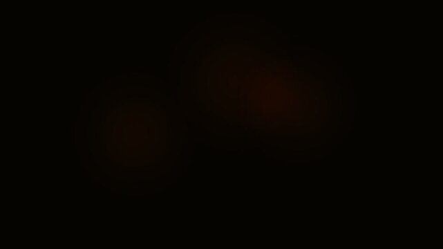 A subtle gradient of deep crimson light emerging from the pitch black darkness