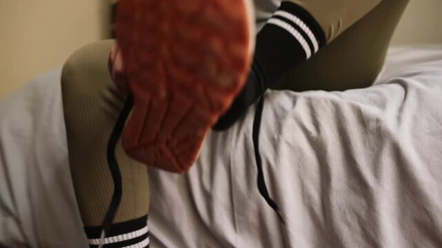 unknown latina athlete tying shoelaces before workout