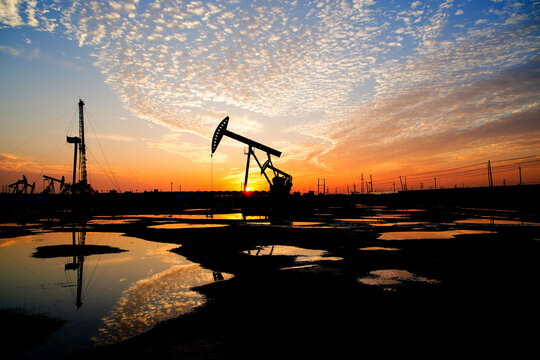 The oil pump, industrial equipment. Oil field site, oil pumps are running.
