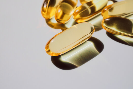 Golden omega-3 gel capsules showing essential healthy supplements for wellness