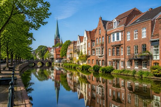 A tranquil canal with brick houses and reflections in Oldenburg.