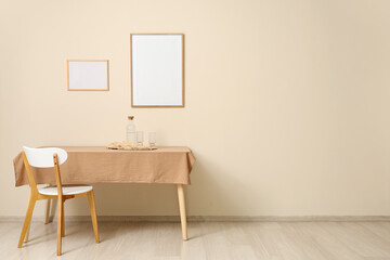 Fototapeta premium Minimalist dining table with chair and empty frames