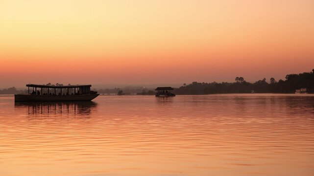 boats on the Zambezi River at sunrise, Zambia, Africa