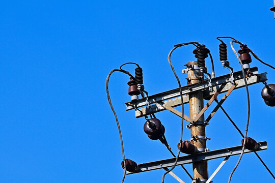 Electrical pole with electrical cables. Energy or power image, Infrastructure. electric. building. cable. high, top. voltage. line, lines. industry, industrial. clear blue sky. copy space, empty, free