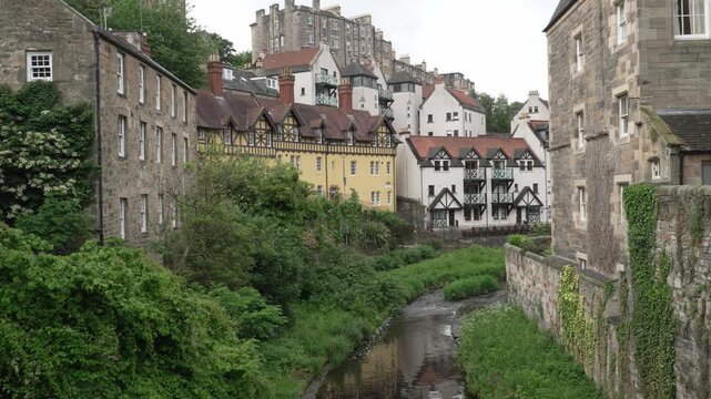 The historic 12th-century milling enclave of Dean Village with red sandstone architecture and the Water of Leith in Edinburgh, Scotland.