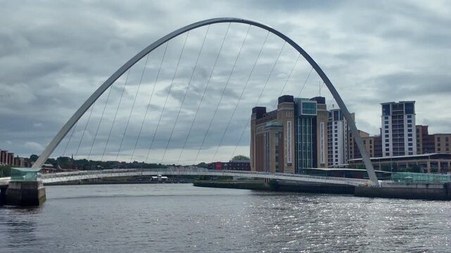 The tilting pedestrian and cyclist Gateshead Millennium Bridge across the River Tyne between Newcastle and Gateshead.