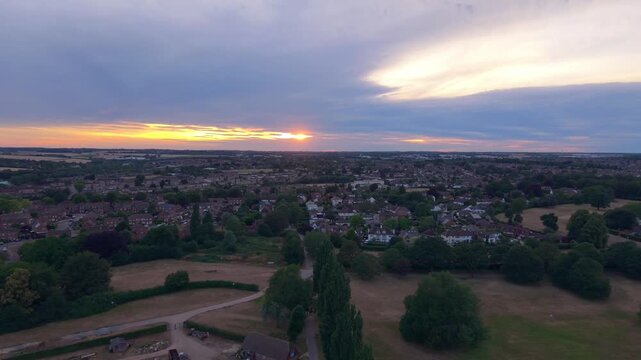 Aerial Sunset Over a Kettering Neighborhood and Park With Dramatic Cloudy Horizon