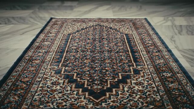 Detailed view of an ornate Persian rug with intricate floral patterns in blue, red, and cream, on a marble floor