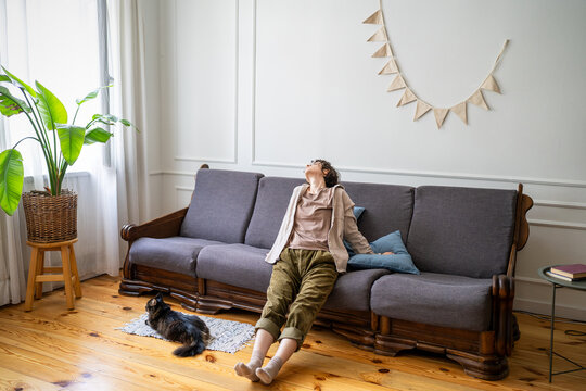 Home boredom, laziness and procrastination, peaceful careless woman resting on couch doing nothing, inactive lazy female distracted by thoughts idling on sofa, dreamy peaceful rest and dallying.