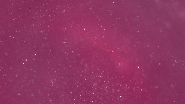 Blur sparkling swirl. Paint water. Pink liquid flowing in round glowing lens. Shiny powder particles color abstract art background.
