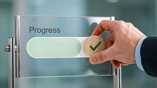 Business hand updating progress status with completed verification on glass interface