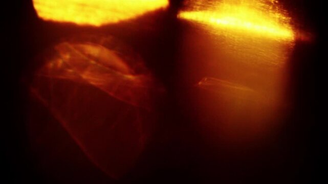 Soft abstract light leaks with glowing warm tones. Atmospheric cinematic overlay, transitions, or background. Seamless loop video