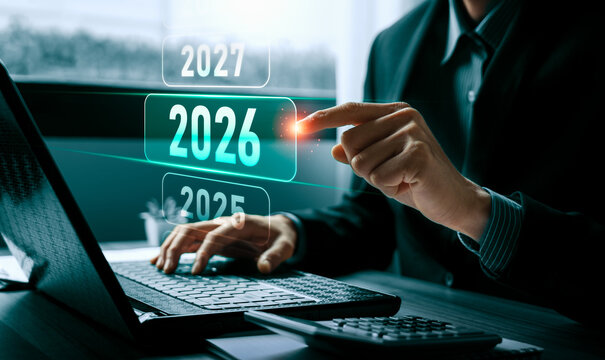Business planning 2026 concept with professional using laptop and calculator touching virtual year interface showing financial forecast strategy budget goals and future growth