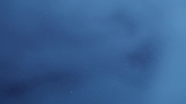 Shimmer mist. Steam blue background. Defocused cold fog sparkling color particles gleam vapor on visual luminous bokeh abstraction.