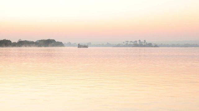 boat and sunrise on the Zambezi River, Zambia, Africa