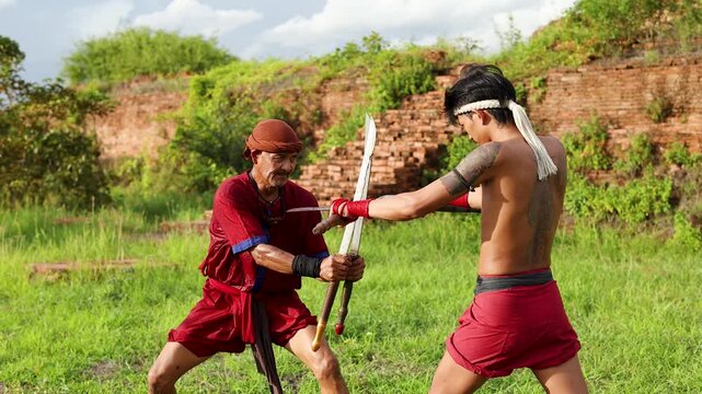 Traditional Thai Martial Artists Sparring with Swords at Ancient Ruins