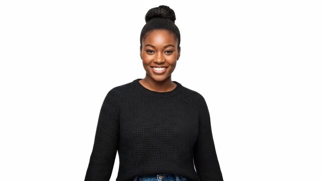 A portrait of a smiling young woman with a hair bun wearing a black sweater