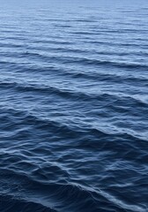 Obraz premium Deep Blue Ocean Water Surface with Gentle Ripples and Small Waves, Abstract Nature Background for Commercial Use