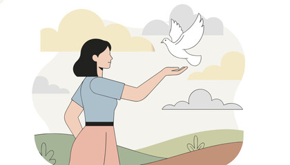 Fototapeta premium Young woman stands in a peaceful landscape and releases a white dove into the sky as a symbol of peace, freedom, and new beginnings.