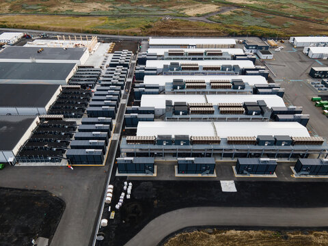 Aerial view of a large data center facility with rows of server containers and industrial infrastructure in Keflavik, Reykjanesbaer, Iceland.