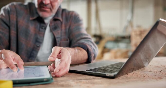 Tablet, carpenter and laptop with hands in workshop for contractor, woodworking update and project. Manufacturing, artisan and furniture supply chain with person in factory for inventory report