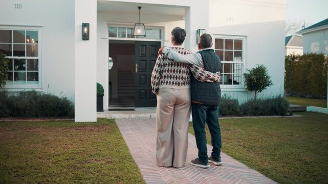 Senior, back or couple with hug at new home for long term investment, security or property purchase. Real estate, people and embrace in front yard for relocation, empty nest or comfortable retirement