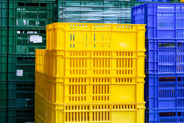 Fototapeta na wymiar Colorful plastic crates arranged in industrial stacks