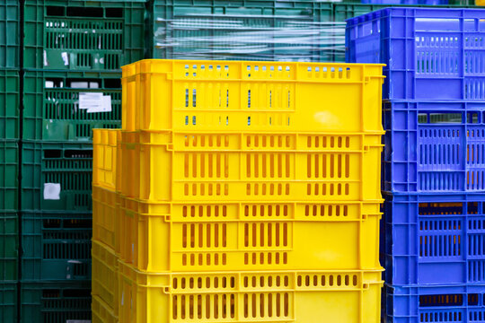 Colorful plastic crates arranged in industrial stacks
