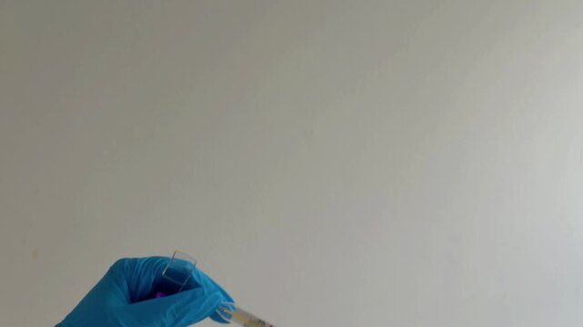 Healthcare professional wearing blue nitrile gloves taking a glass mercury thermometer out of its protective case, isolated on a white background
